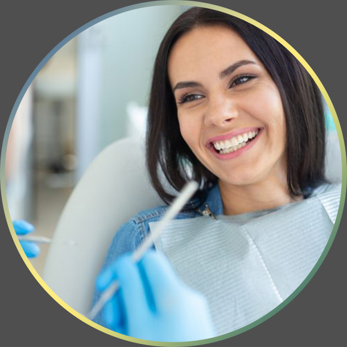 Woman smiling while getting her teeth checked by her dentist.