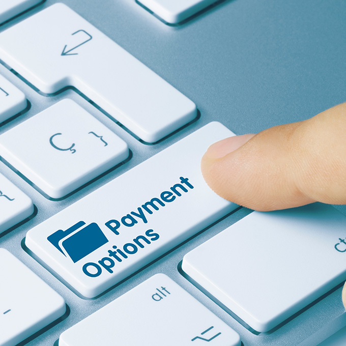 Person pressing Payment Options on their laptop keyboard