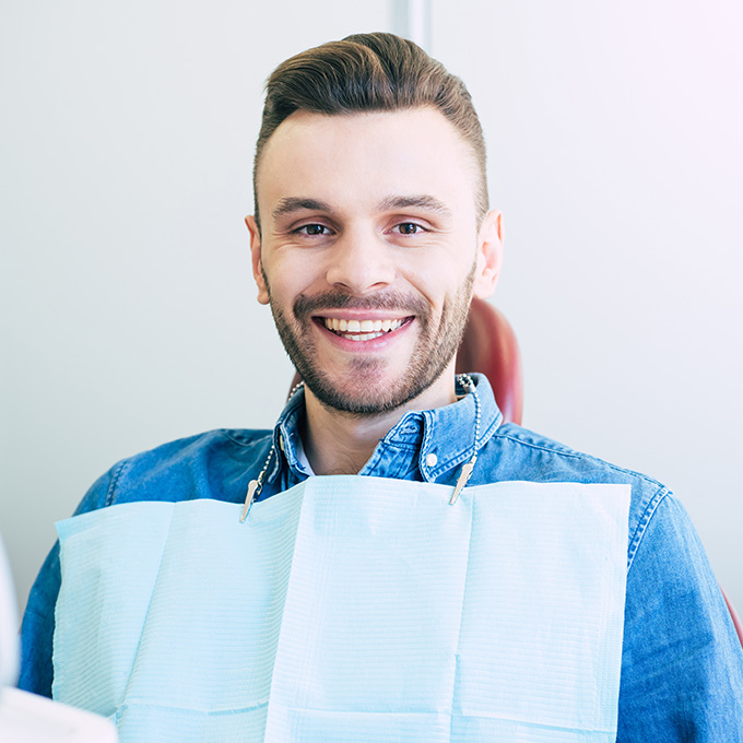 Cure response. Handsome man in denim shirt and a special napkin