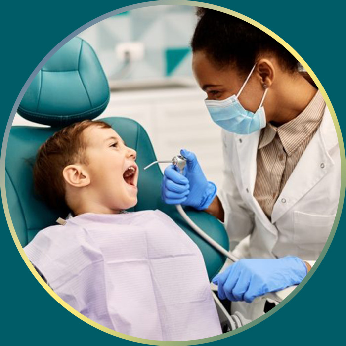 Child having water sprayed into his mouth by dentist